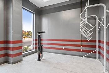 the lobby of a building with a fire hydrant and a ladder on the wall
